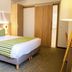 Hôtel Restaurant Au Boeuf in Blaesheim, guest room with striped bedding and sliding wooden closet doors