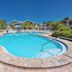 Best Western Plus Yacht Harbor Inn in Dunedin with outdoor pool, palm trees, and sunny resort setting