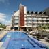 Hotel Tahiti Nui in Papeete with a rooftop pool, lounge chairs, and a modern hotel exterior