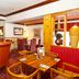 Premier Inn Huddersfield Central restaurant dining area with wooden tables and leather chairs