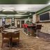 Best Western Plus St. Albert lobby bar with tables, chairs and red bar stools in Saint Albert