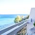 Karystion Hotel in Kárystos balcony with table and chairs overlooking the sea