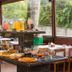 Hotel Serra Everest in Nova Friburgo buffet table with juices, pastries, and breakfast items