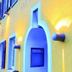 Klozbücher - Das Landhotel in Ellwangen, yellow stucco exterior with arched blue doorway and wall lights