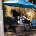 Lost Bayou Guesthouse in Galveston outdoor patio with blue umbrella and seating