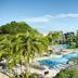 Hilton Orlando Lake Buena Vista - Disney Springs Area with palm-lined resort pool and high-rise hotel exterior in Lake Buena Vista