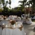 Hotel Mediterraneo Plaza in San Salvador outdoor garden dining setup with tables and palm trees