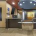 Best Western Plus St. Albert hotel reception desk with two counters and circular ceiling lights