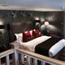 Eglinton Arms Hotel, Glasgow guest room with king bed, patterned wallpaper, lamps and plaid carpet