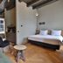 Hotel Abdij Dokkum room in Dokkum with bed, seating area, and wood herringbone floor