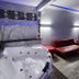 Motel 6 Little Rock North in North Little Rock spa tub and red chaise lounge in a modern room