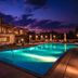 Vitina House in Vytina with lit outdoor pool and stone hotel exterior at dusk