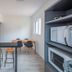 Hotel Melo in Balneário Camboriú: compact kitchenette with dining table and microwave