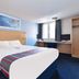 Travelodge Manchester Birch M62 Eastbound room with double bed, desk, window and TV in Heywood