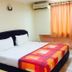 City Star Hotel Kulai guest room with double bed, orange curtains and air conditioner in Kulai