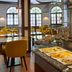 Breakfast buffet at Leonardo Hotel & Residenz München in Munich with fruit, pastries and seating