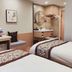 Yangjianhua Hotel in Shanghai room with two beds, desk, mirror, and compact sink area