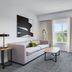 Homewood Suites by Hilton Louisville-East room with sofa, desk, TV and window view in Louisville