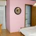 Jaegerstube in Görgeshausen guest room with pink walls, bed, round mirror and bathroom door