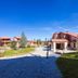 Vitina House in Vytina with stone walkway, landscaped grounds, and chalet-style buildings under blue sky