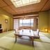 Hotel Kazuno in Kazuno tatami room with low table, chairs, and large window view