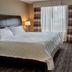 Hilton Garden Inn St. Louis Airport guest room with king bed, window and TV in St. Louis