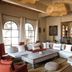 Le Jardin Des Douars in Essaouira lounge with white sectional sofas, rustic coffee table and bar area