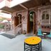 Hotel Harasar Haveli in Bikaner entrance courtyard with carved stone facade and colorful seating