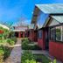 Keuhenua Hostal in Hanga Roa with tropical garden path and bungalow-style guest rooms