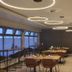 Hotel Lindleinsmühle Wurzburg dining room with modern ring ceiling lights and set tables