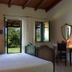 Domo Minnannu Miriu room with bed, open windows, and garden view in Loiri Porto San Paolo