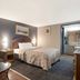 Scottish Inns Harrisburg-Hershey South guest room in New Cumberland with bed, sofa, and adjoining bathroom