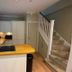 The Old Railway Station, Petworth: compact hotel kitchenette with wood countertop, sink, cabinets and staircase