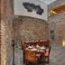 Hotel Boutique Casareyna in Puebla City: stone-walled restaurant with wooden tables in a courtyard setting