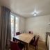 Villa Montmartre in Paris: small dining area with wooden table, four chairs, and window view