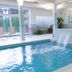 Indoor pool with waterfall feature at Hotel Fraga do Eume in Capela
