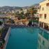Lamedina Hotel & Resort in Jounieh with outdoor pool, sun loungers, palm trees and bay views