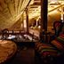 Karczma Rzym in Bydgoszcz: rustic loft seating area with lace-covered table and warm wooden beams