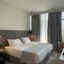 Palladion Boutique Hotel in Árgos, guest room with a double bed, desk, chair and tall window