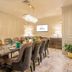 Hotel Himalaya Kathmandu dining room with long glass table, velvet chairs, chandelier and buffet sideboard