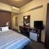 Hotel Route-Inn Tokuyama Ekimae room in Shunan with bed, desk, chair, TV and mini fridge