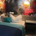 Zur Fichtenbreite in Klieken room with double bed, teal bed runner, bedside lamps, and graffiti wall