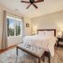 Chateau de Vie in Calistoga guest room with king bed, bench, nightstands, and window view.