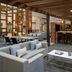 Cleveland Marriott East lobby lounge with gray sofas, marble coffee table and wood-accented bar in Warrensville Heights