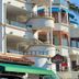 Casa Tropicana in San Clemente with curved balconies and a green awning