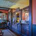 Mendocino Hotel and Garden Suites lobby with ornate wood front desk and antique mirror