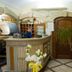 Hotel San Francisco in Dorgali: cozy hotel reception with wood counter, potted plant, and arched doorway