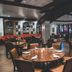 Cannery Casino Hotel in North Las Vegas restaurant interior with round tables and red banquettes