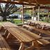 Waitomo Top 10 Holiday Park outdoor picnic shelter with wooden tables and grassy park views
