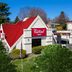 Red Roof Inn Warrenton exterior in Warrenton with red roof, entrance sign, and parking lot